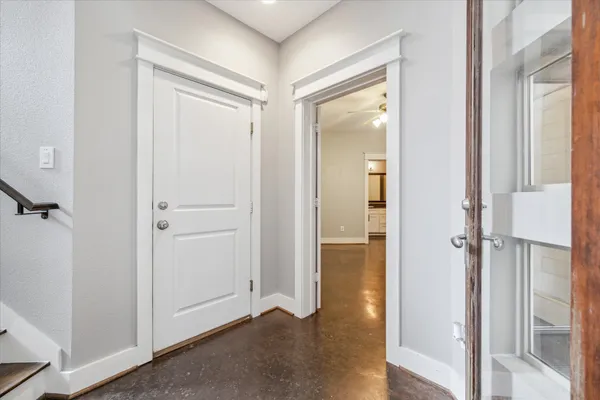 an empty room with fan and windows