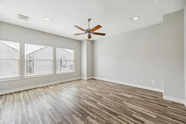 a view of a livingroom with a ceiling fan and wooden floor