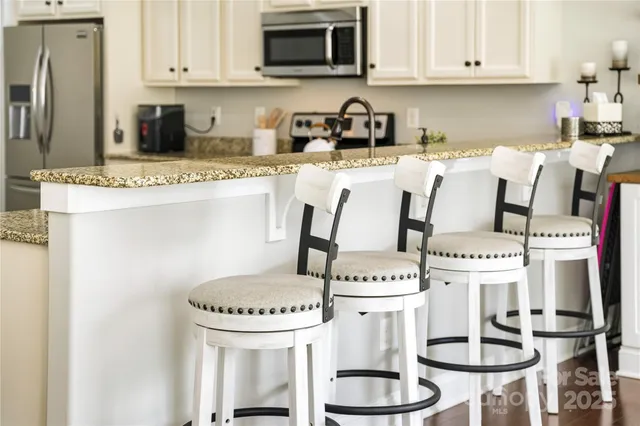 a kitchen with a stove a refrigerator and cabinets