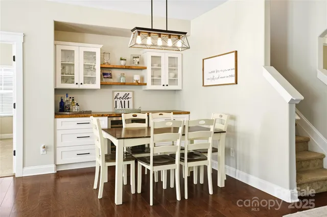 a view of a center island and wooden floor