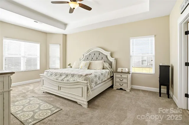 a bedroom with a bed a couch and dresser