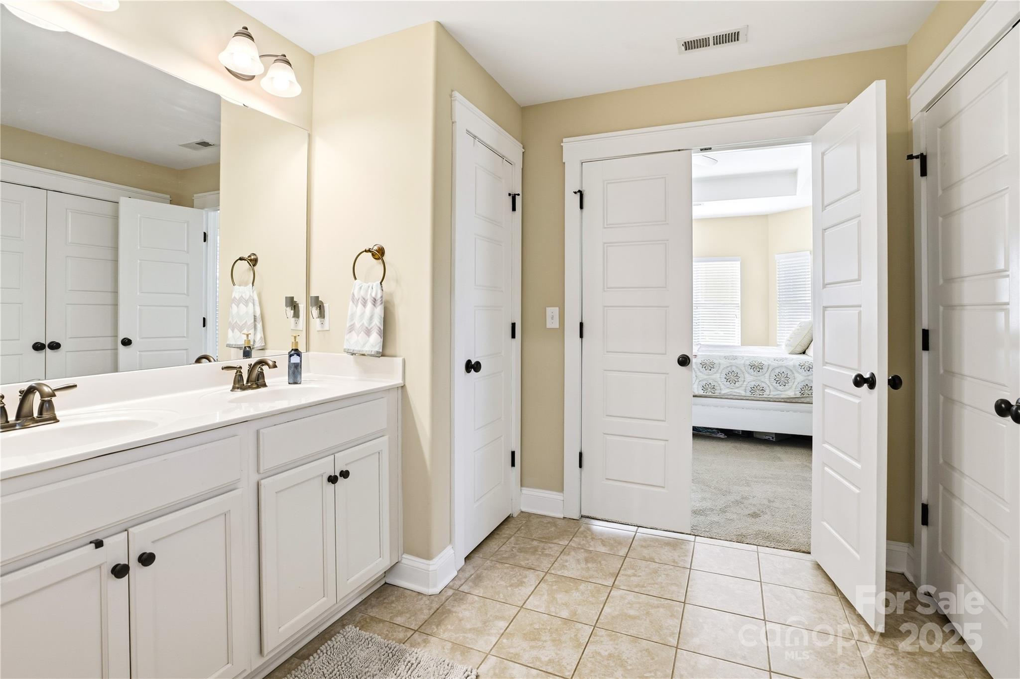 3168 Delaware Drive Denver, NC 28037 - Photo 23 of 47 a en suite bathroom with a double vanity sink a mirror and a shower