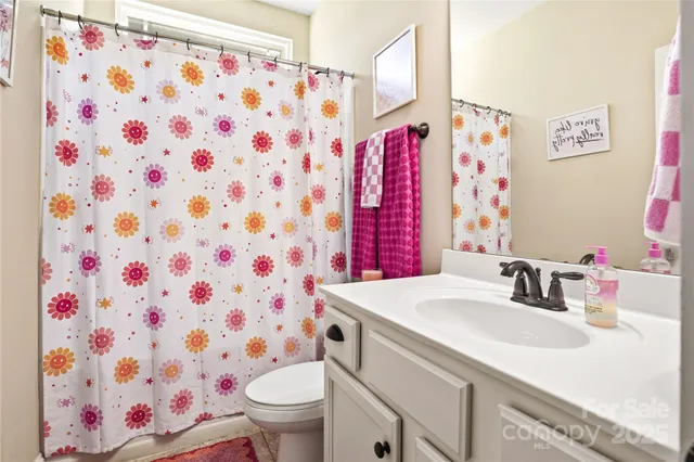 a bedroom with bed and a flat screen tv