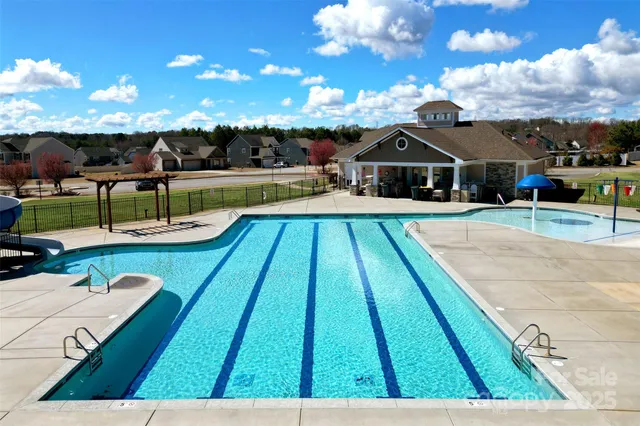 a view of a swimming pool with a yard