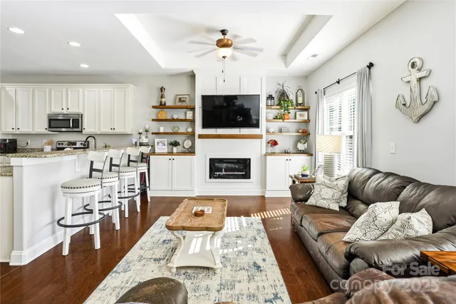 a living room with furniture a flat screen tv and a fireplace