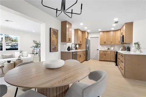 a kitchen with stainless steel appliances kitchen island granite countertop a sink and cabinets