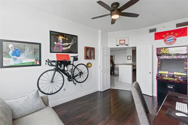 a view of a livingroom with furniture a ceiling fan and windows