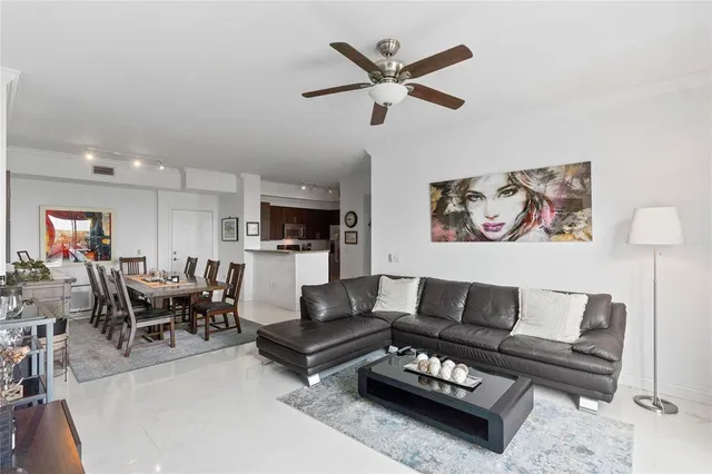 a living room with furniture a rug and a view of kitchen