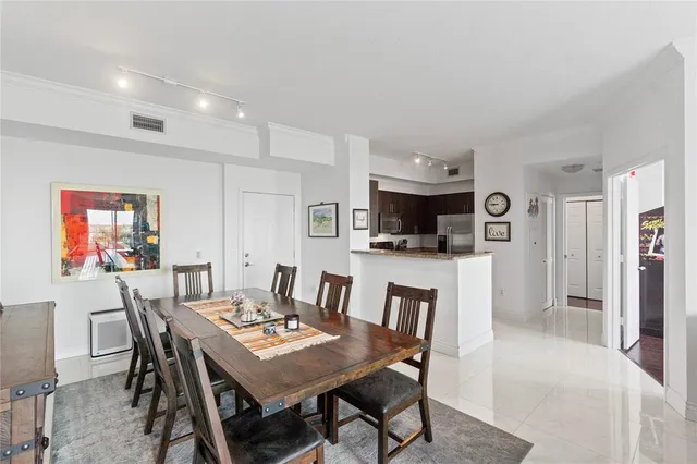 a view of a dining room with furniture and a kitchen