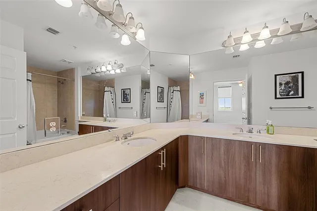 a bathroom with a sink vanity granite and a mirror
