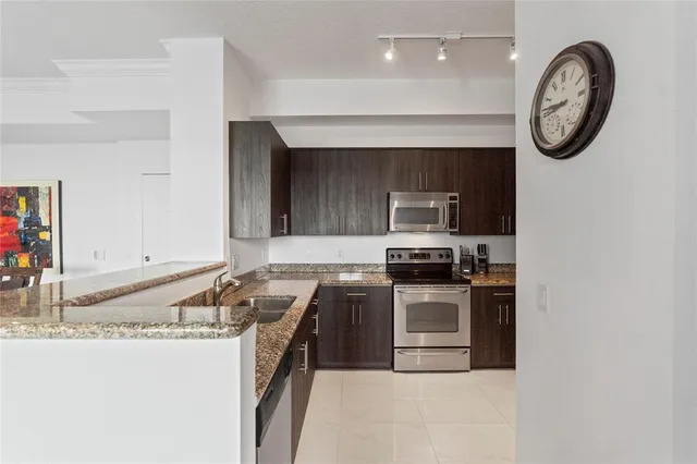 a kitchen with granite countertop a stove top oven