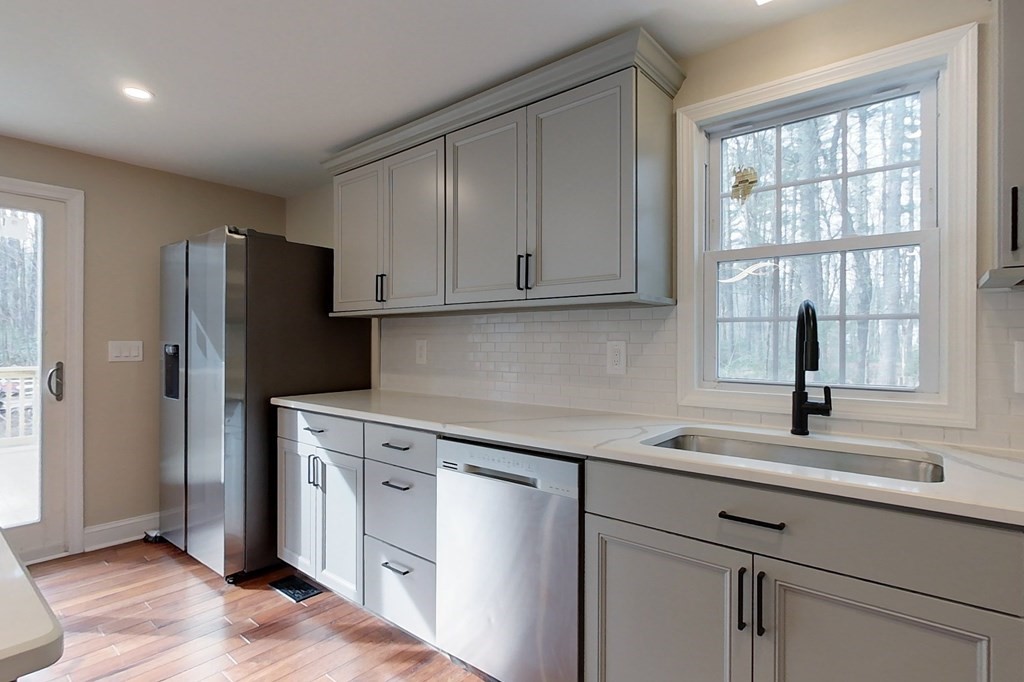 31 Turner Road Townsend, MA 01469 - Photo 4 of 38 a kitchen with stainless steel appliances white cabinets and a window