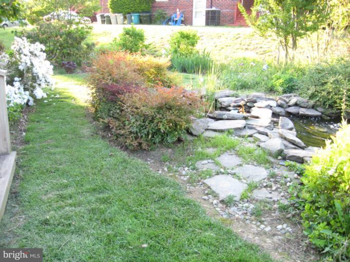 6601 Pimlico Road Baltimore, MD 21209 - Photo 7 of 12 a backyard of a house with table and chairs