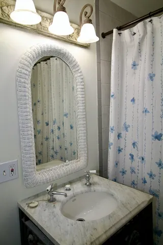 a view of an empty room with window and bathroom