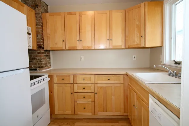 a kitchen with granite countertop cabinets and sink