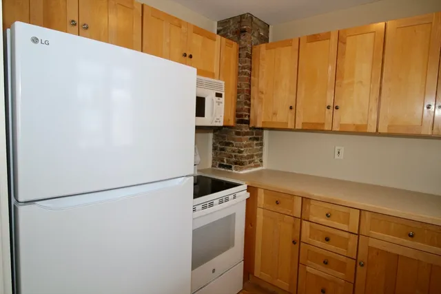 a kitchen with stainless steel appliances a refrigerator sink and cabinets