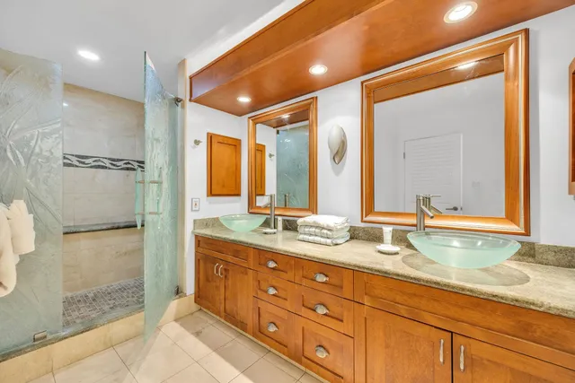 a bathroom with a granite countertop sink mirror and double