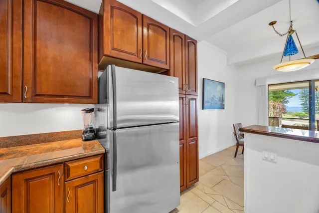 a kitchen with stainless steel appliances granite countertop a refrigerator a stove a sink dishwasher and microwave with wooden floor