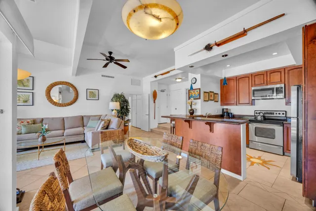 a living room with furniture kitchen view and a window
