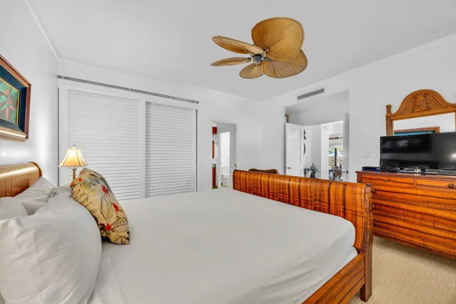 a bedroom with bed and a chandelier