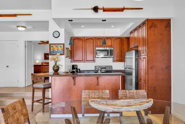 a kitchen with a refrigerator a stove a sink and dishwasher with wooden floor