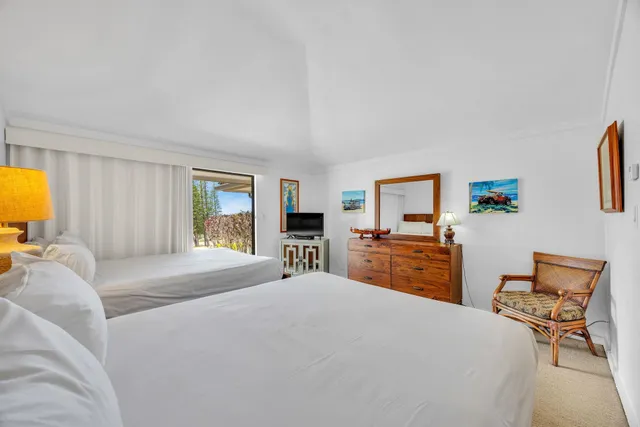 a bedroom with a bed and wooden furniture