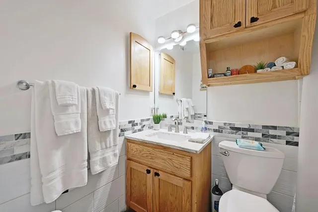 a bathroom with a sink a toilet and shower
