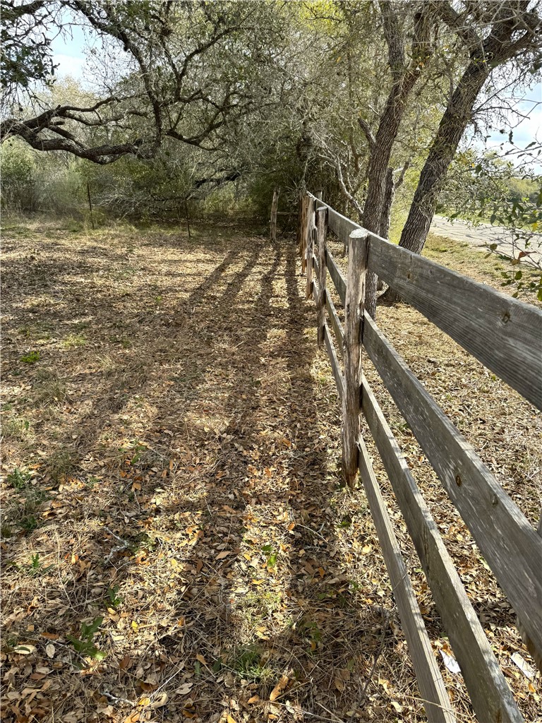 1632 Slickfield Road Yorktown, TX 78164 - Photo 8 of 40 a view of a yard with wooden fence