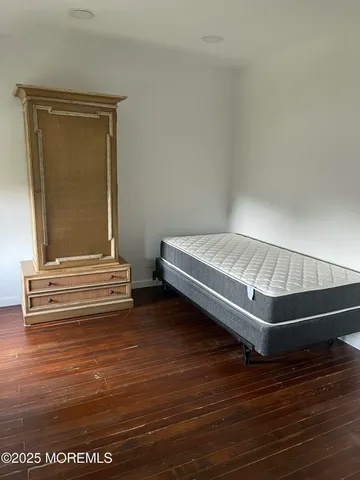 a view of room with wooden floor and cabinet