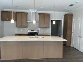 a kitchen with a refrigerator a sink and a stove top oven