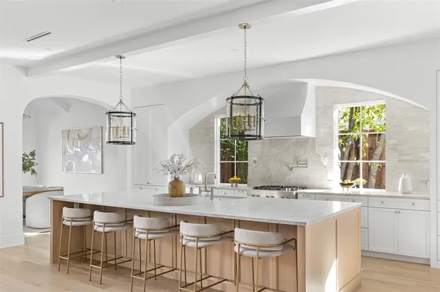a kitchen with granite countertop a sink a center island and cabinets