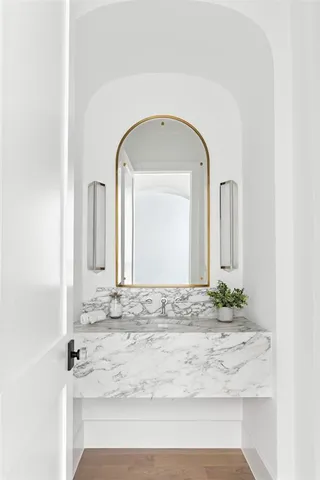 a view of bathroom with granite countertop a sink and mirror