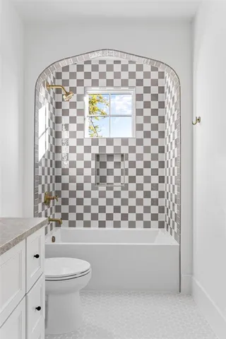 a bathroom with a toilet and a shower curtain