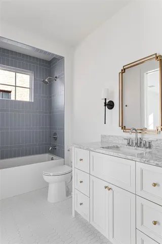 a bathroom with a granite countertop toilet a sink and a bathtub