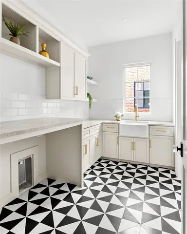 a kitchen with a checkered floor and white cabinets