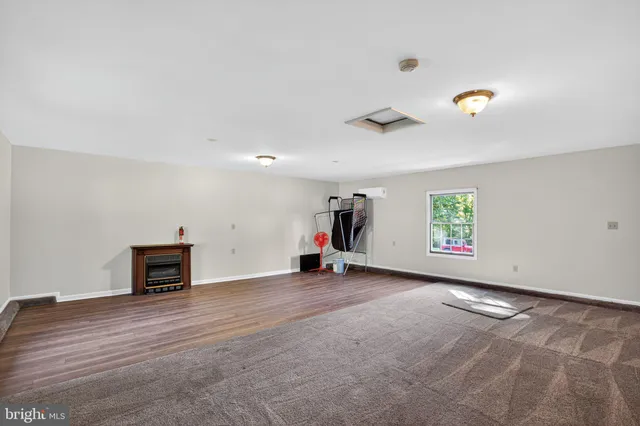 an empty room with furniture and a ceiling fan