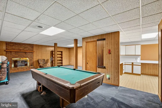 a room with pool table and a large window