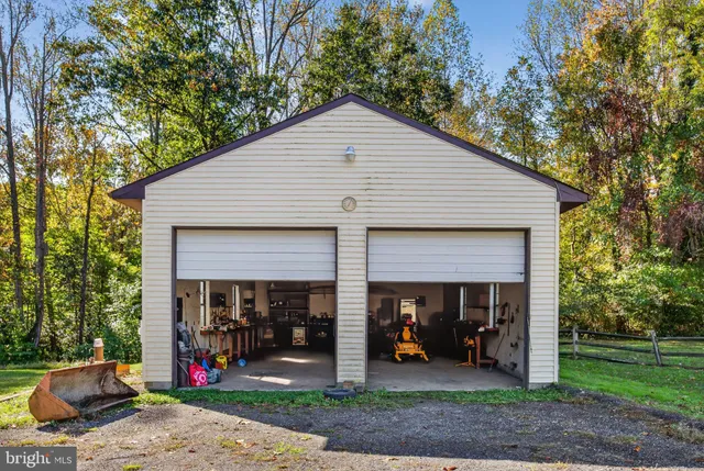 a view of a house with small yard and garage