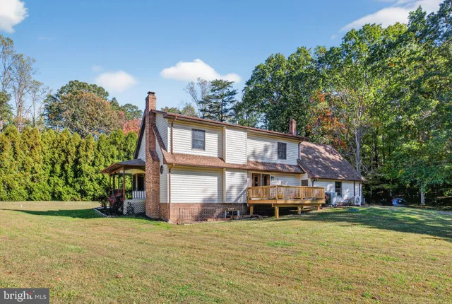 a front view of a house with a yard and trees