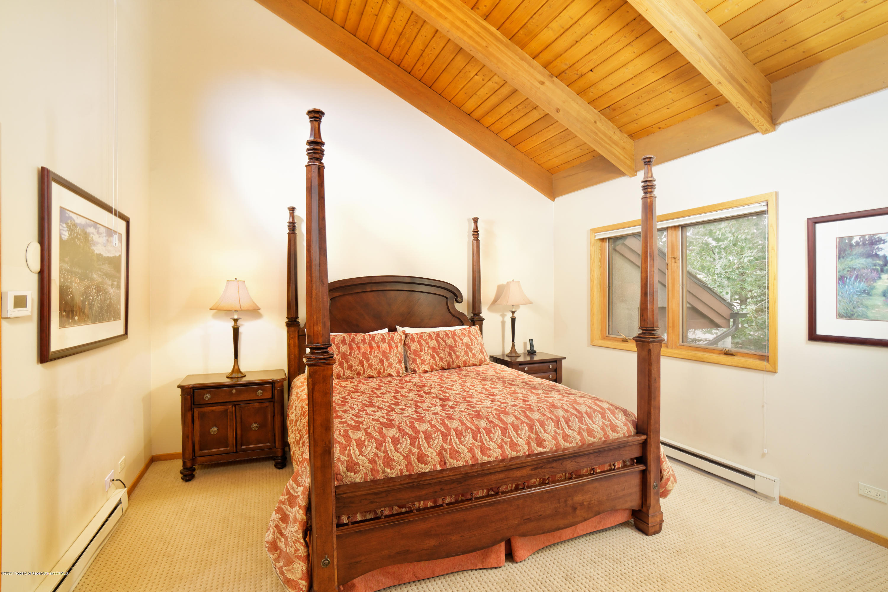 800 Ridge Road, Unit 9 Snowmass Village, CO 81615 - Photo 13 of 42 a bedroom with a bed next to a window