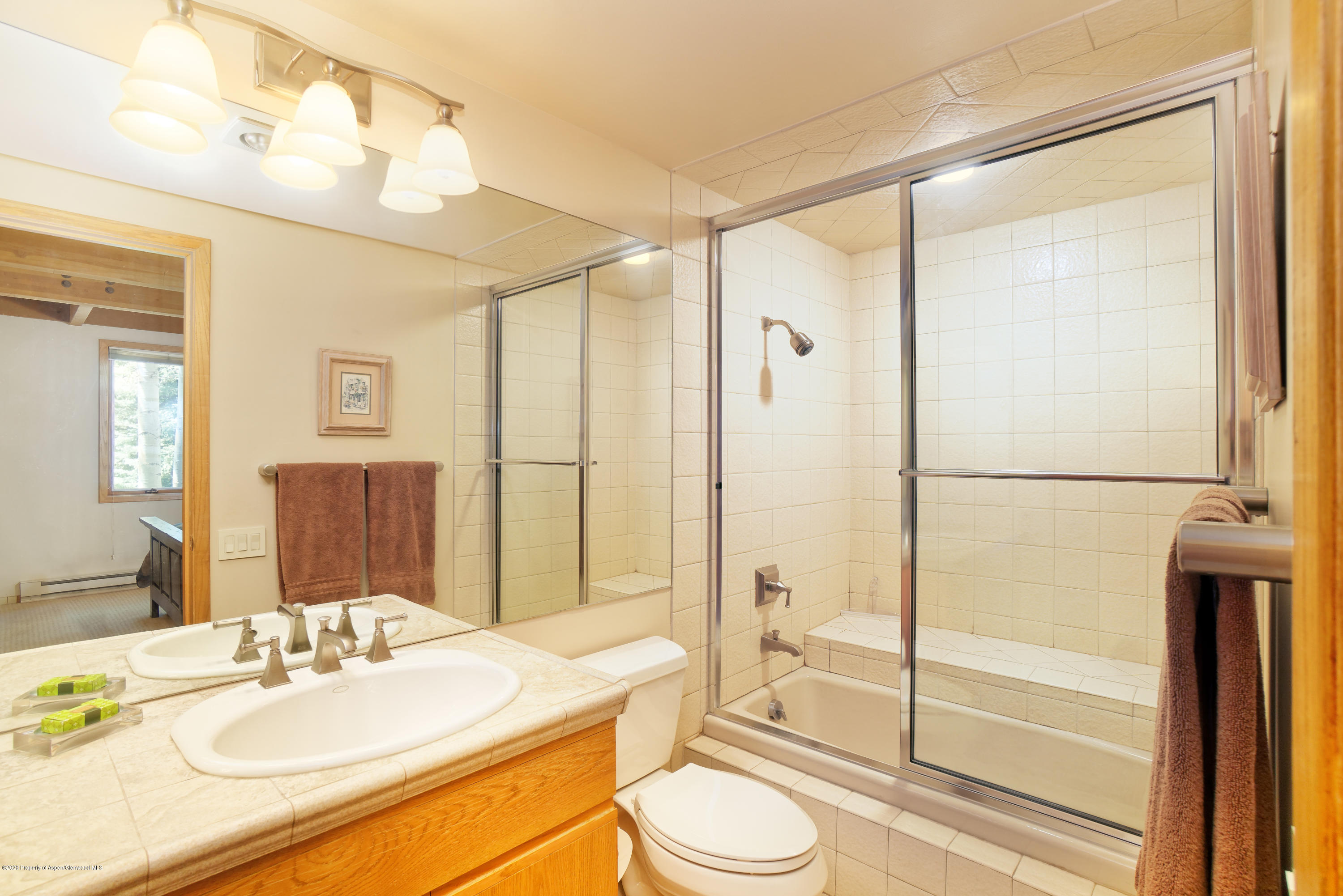 800 Ridge Road, Unit 9 Snowmass Village, CO 81615 - Photo 14 of 42 a bathroom with a granite countertop sink toilet and shower