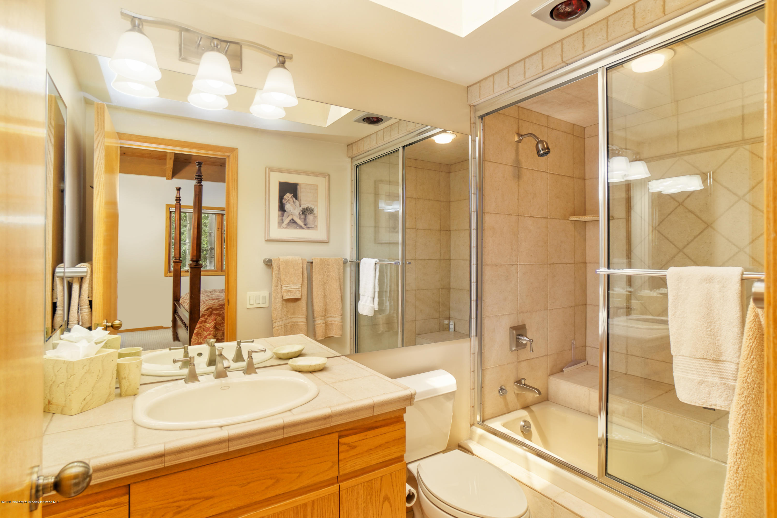 800 Ridge Road, Unit 9 Snowmass Village, CO 81615 - Photo 16 of 42 a bathroom with a double vanity sink toilet mirror and shower