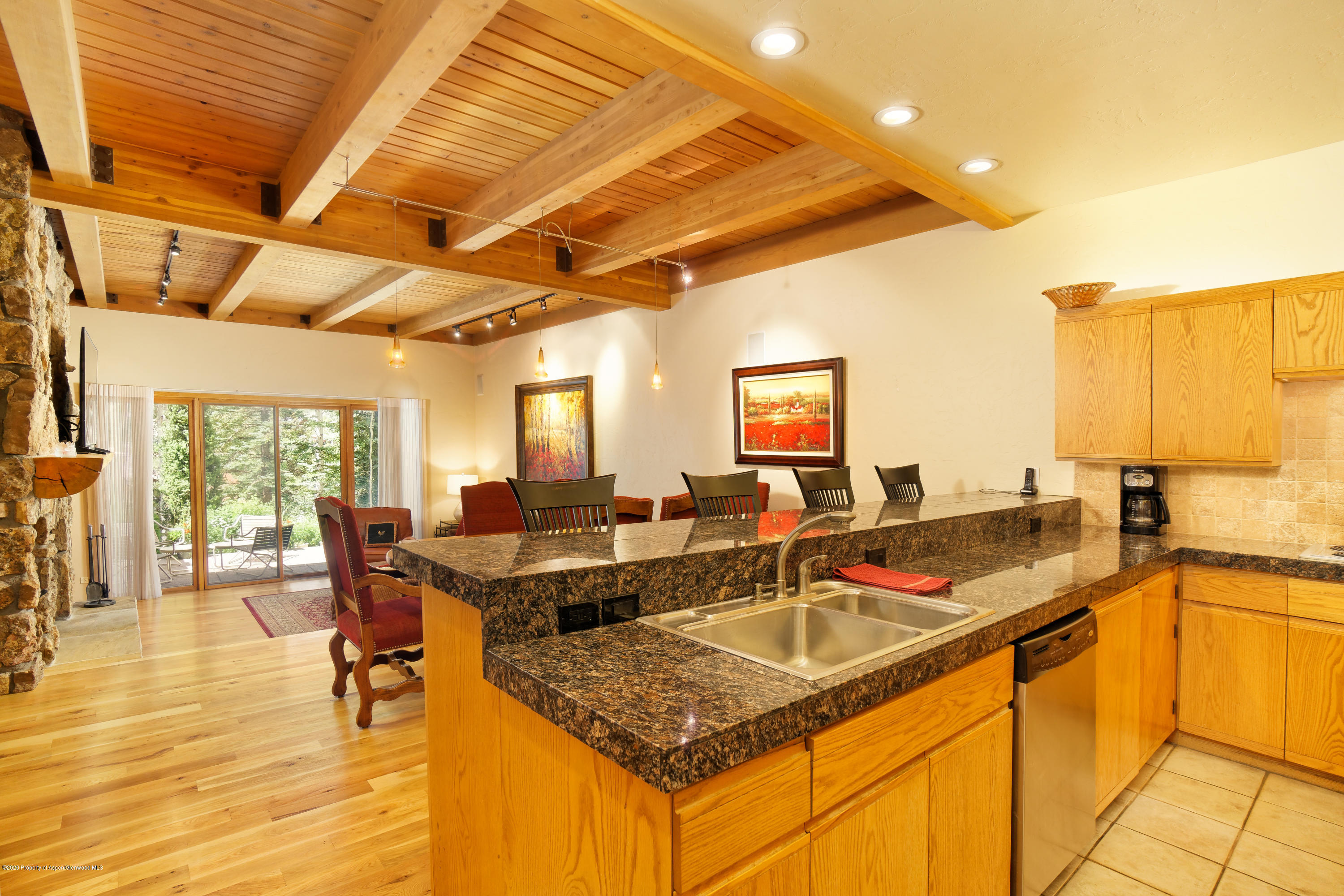 800 Ridge Road, Unit 9 Snowmass Village, CO 81615 - Photo 2 of 42 a kitchen island with granite countertop sink and cabinets