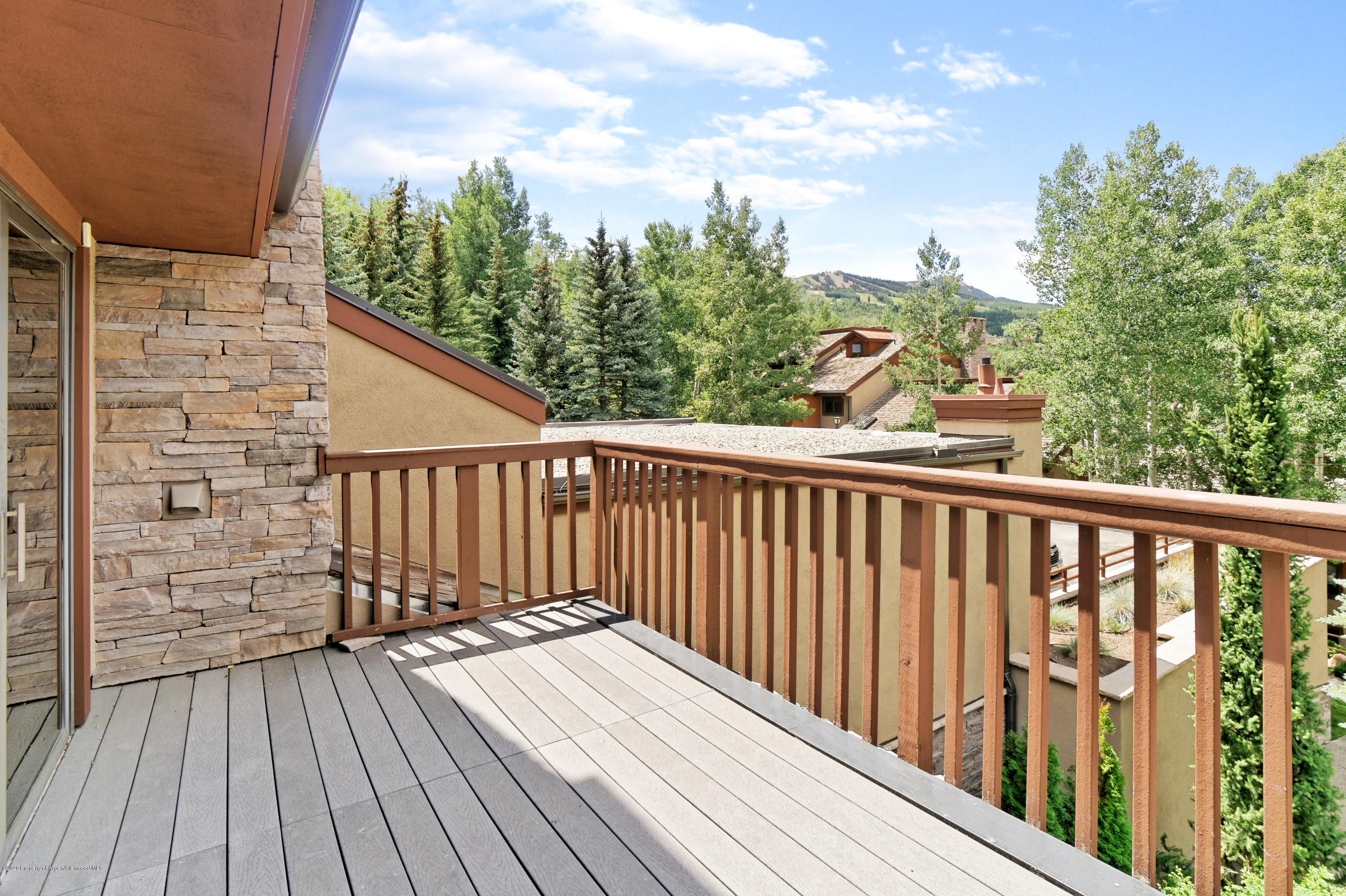 800 Ridge Road, Unit 9 Snowmass Village, CO 81615 - Photo 22 of 42 a view of balcony with wooden floor and fence