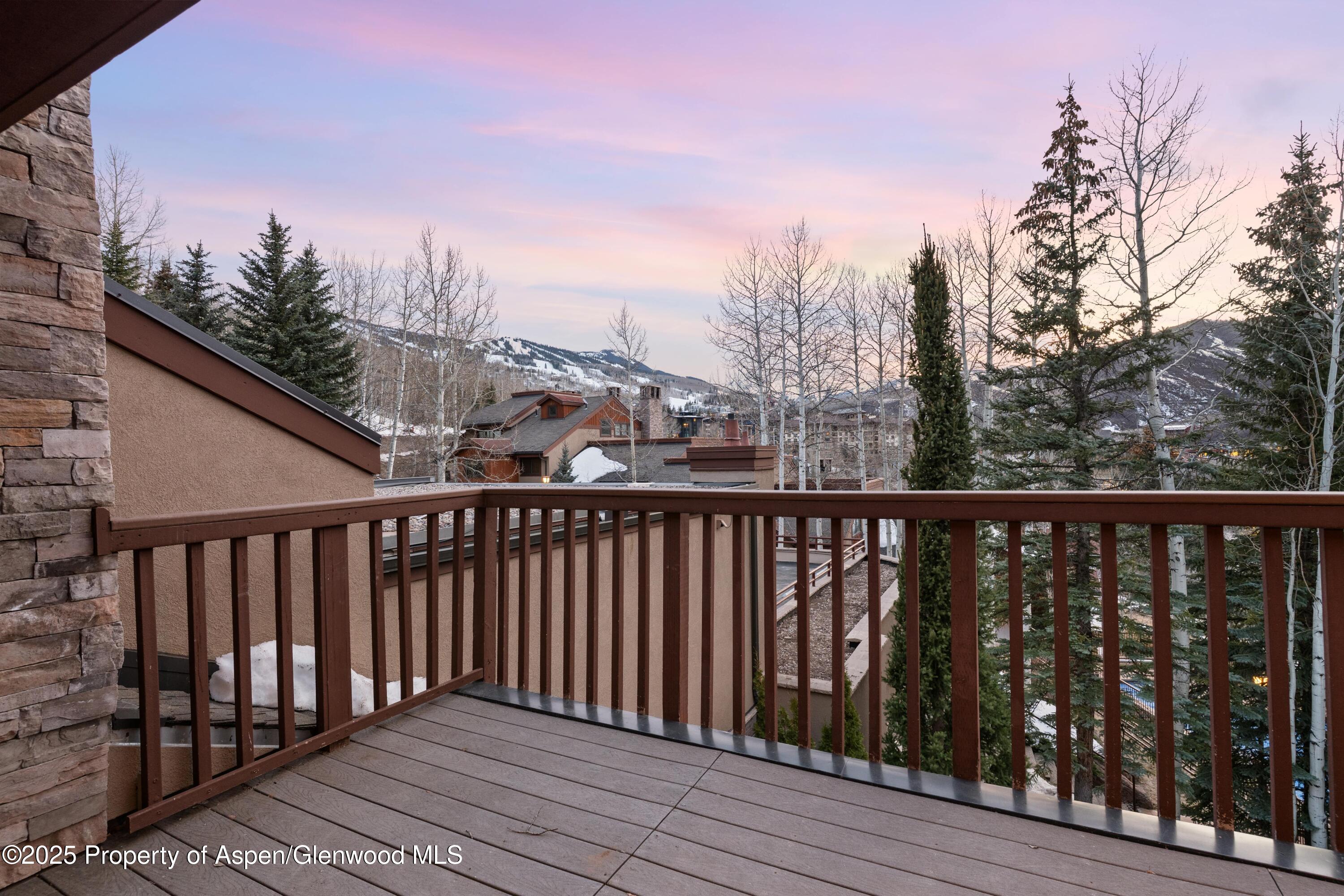 800 Ridge Road, Unit 9 Snowmass Village, CO 81615 - Photo 23 of 42 a balcony with wooden floor and fence