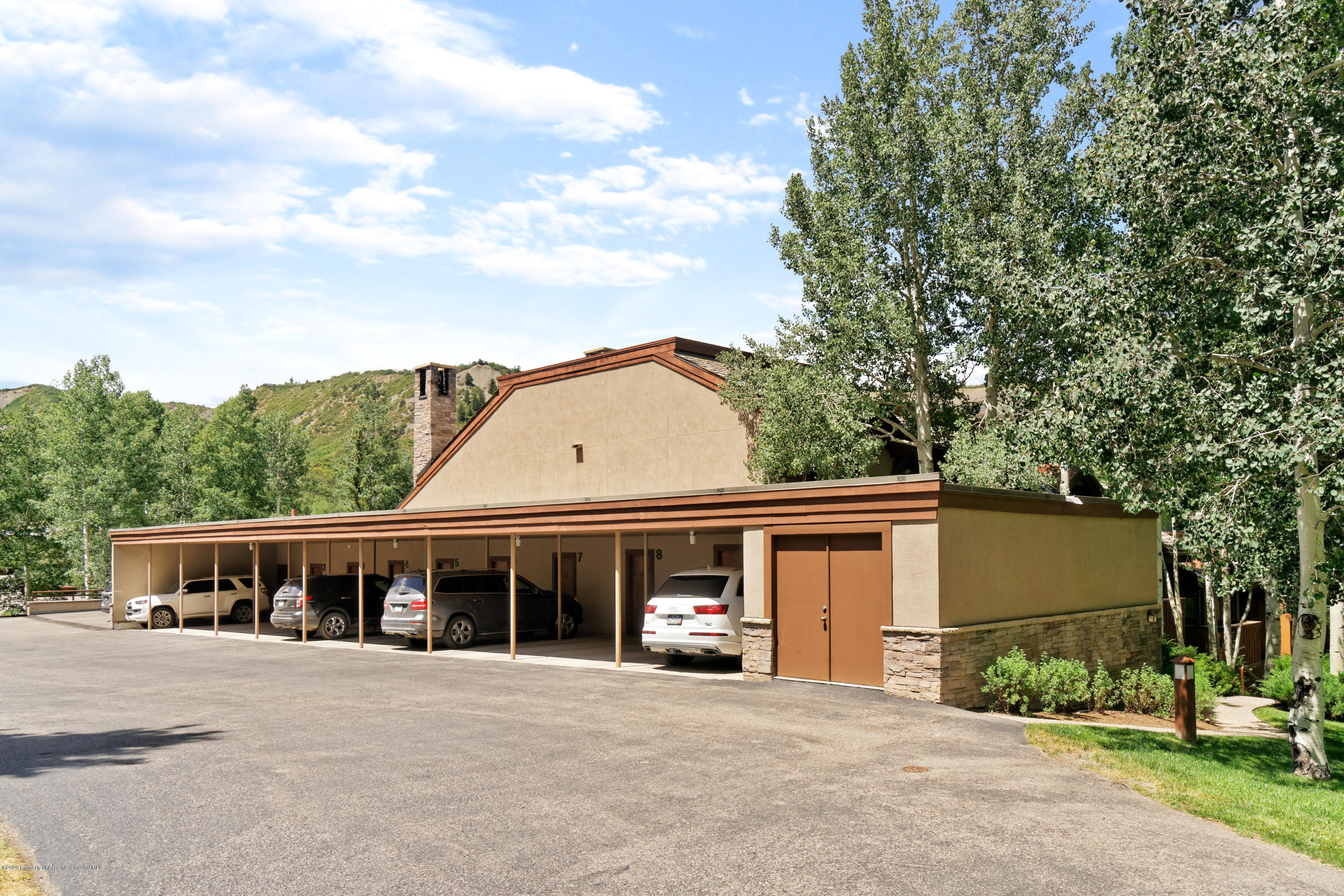800 Ridge Road, Unit 9 Snowmass Village, CO 81615 - Photo 32 of 42 a front view of a house with a garden