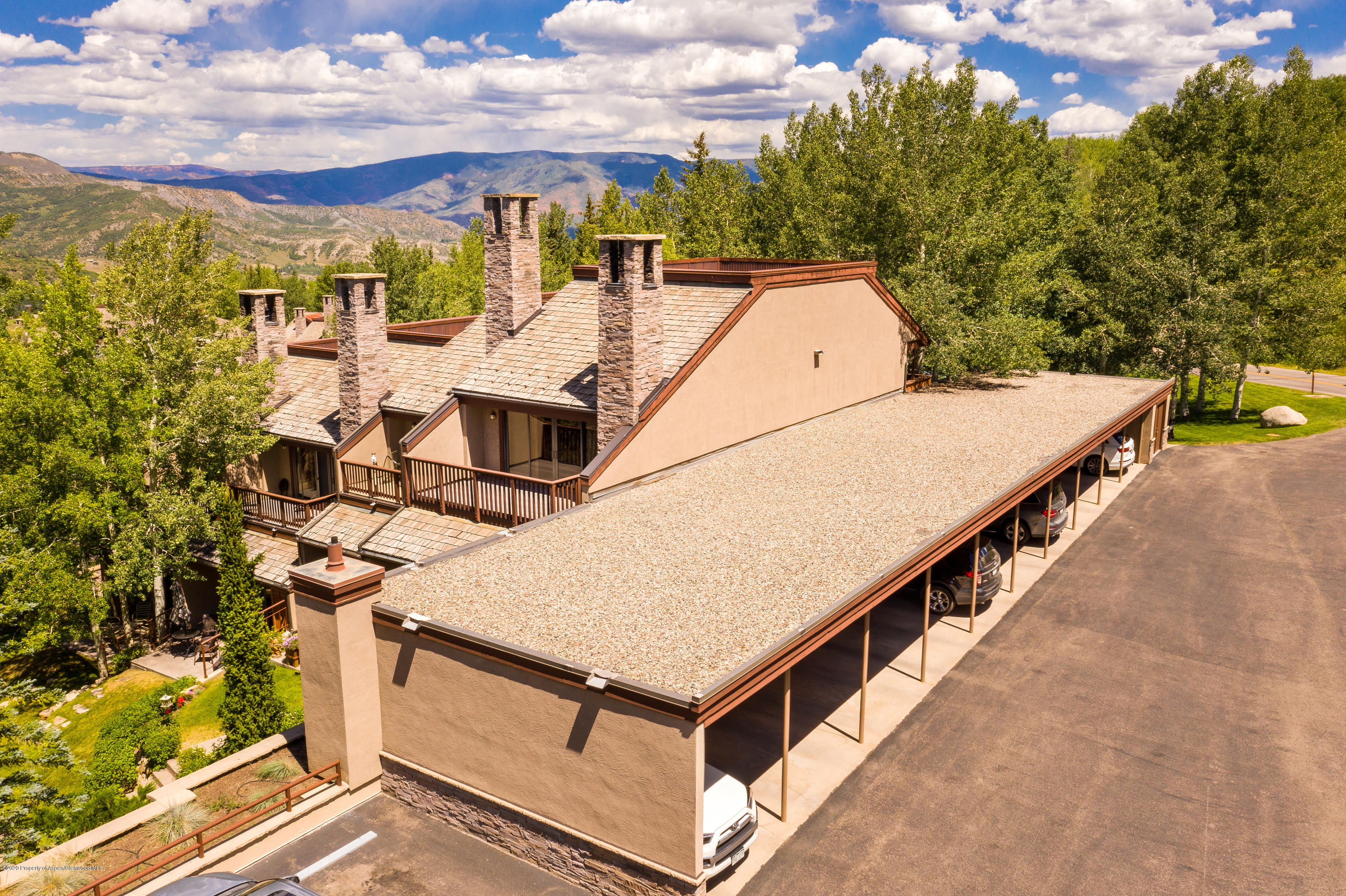 800 Ridge Road, Unit 9 Snowmass Village, CO 81615 - Photo 33 of 42 a view of a patio with a table and chairs