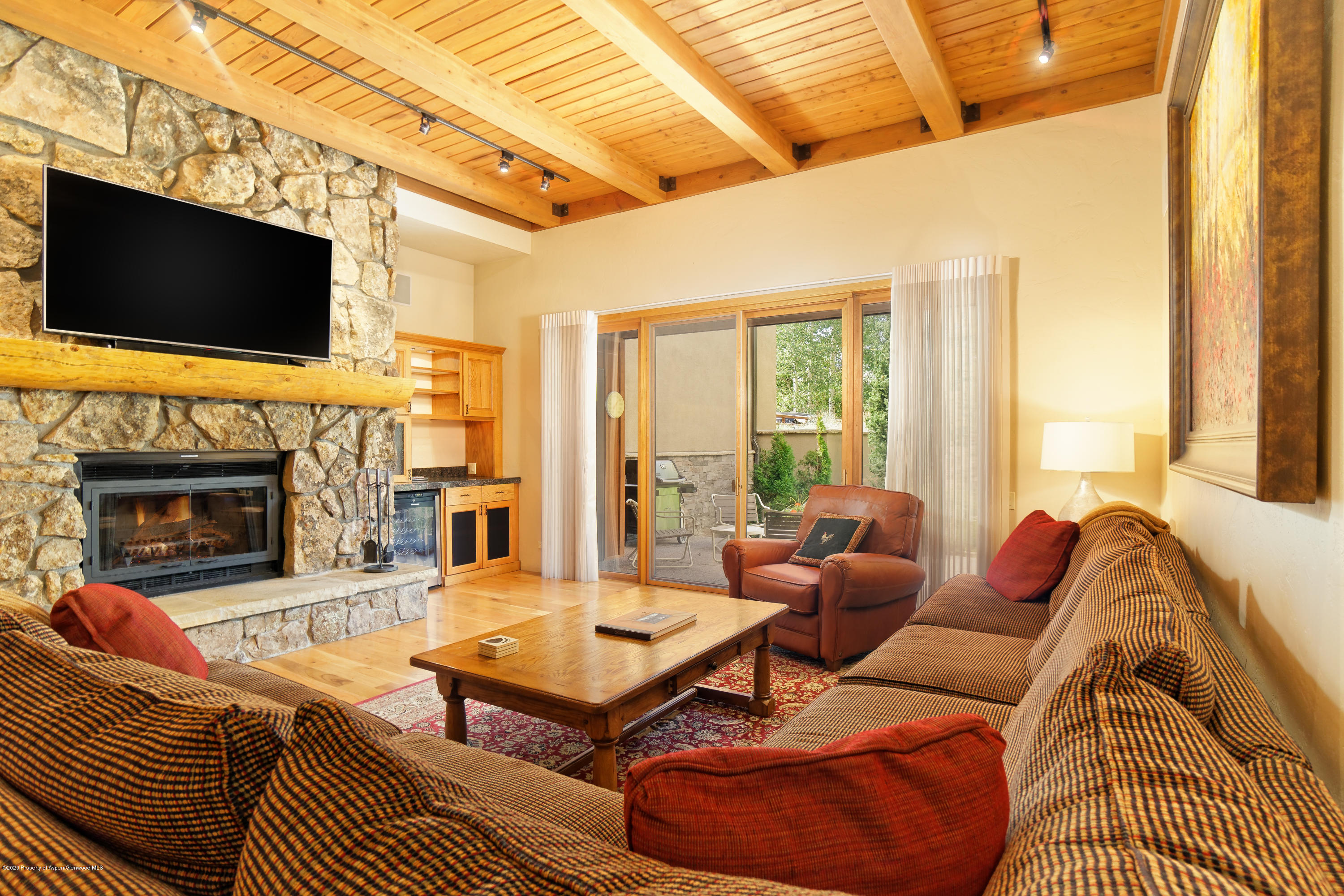 800 Ridge Road, Unit 9 Snowmass Village, CO 81615 - Photo 4 of 42 a living room with furniture a flat screen tv and a fireplace