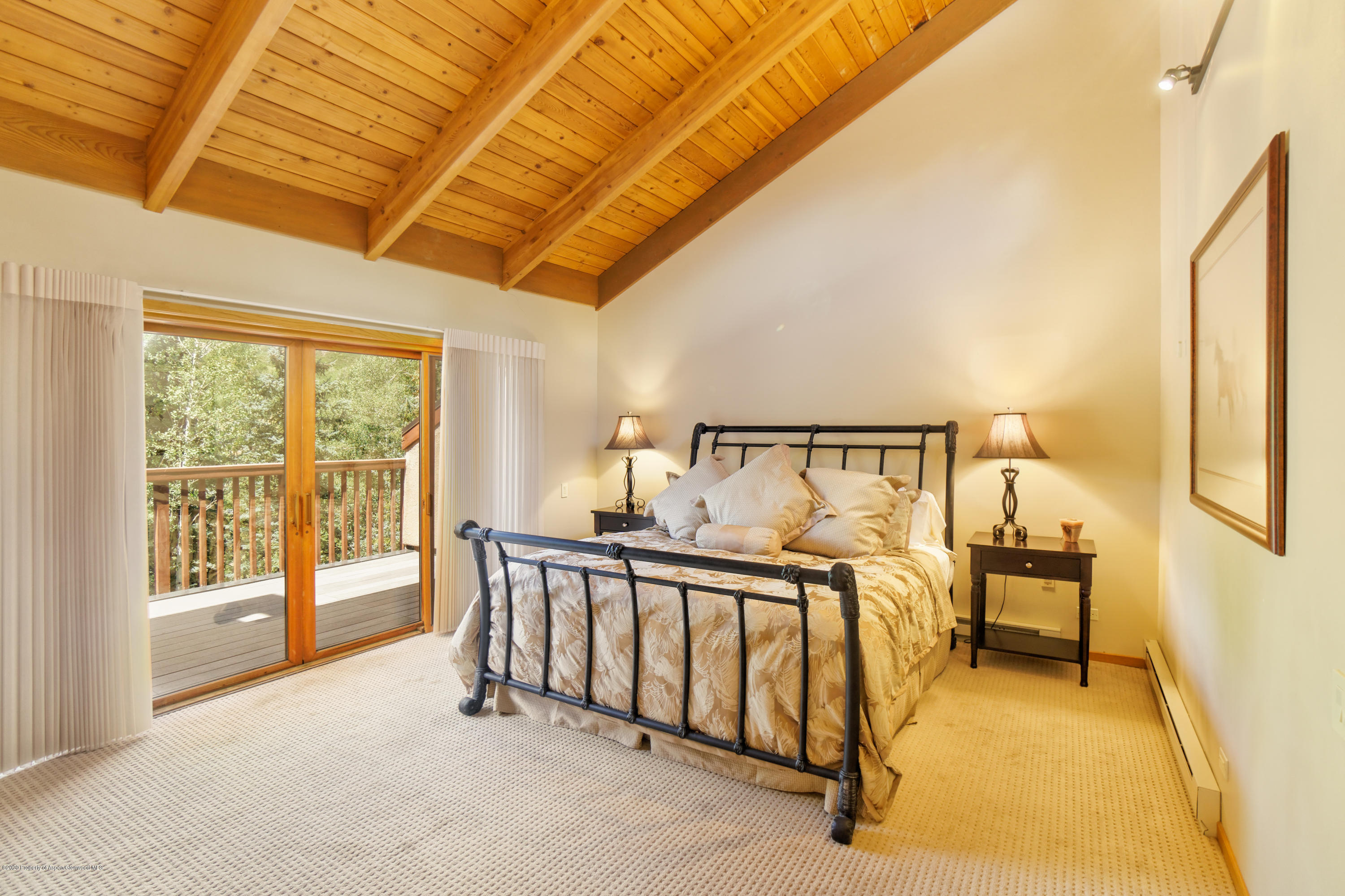 800 Ridge Road, Unit 9 Snowmass Village, CO 81615 - Photo 10 of 42 a view of a spacious bedroom with a bed and a window