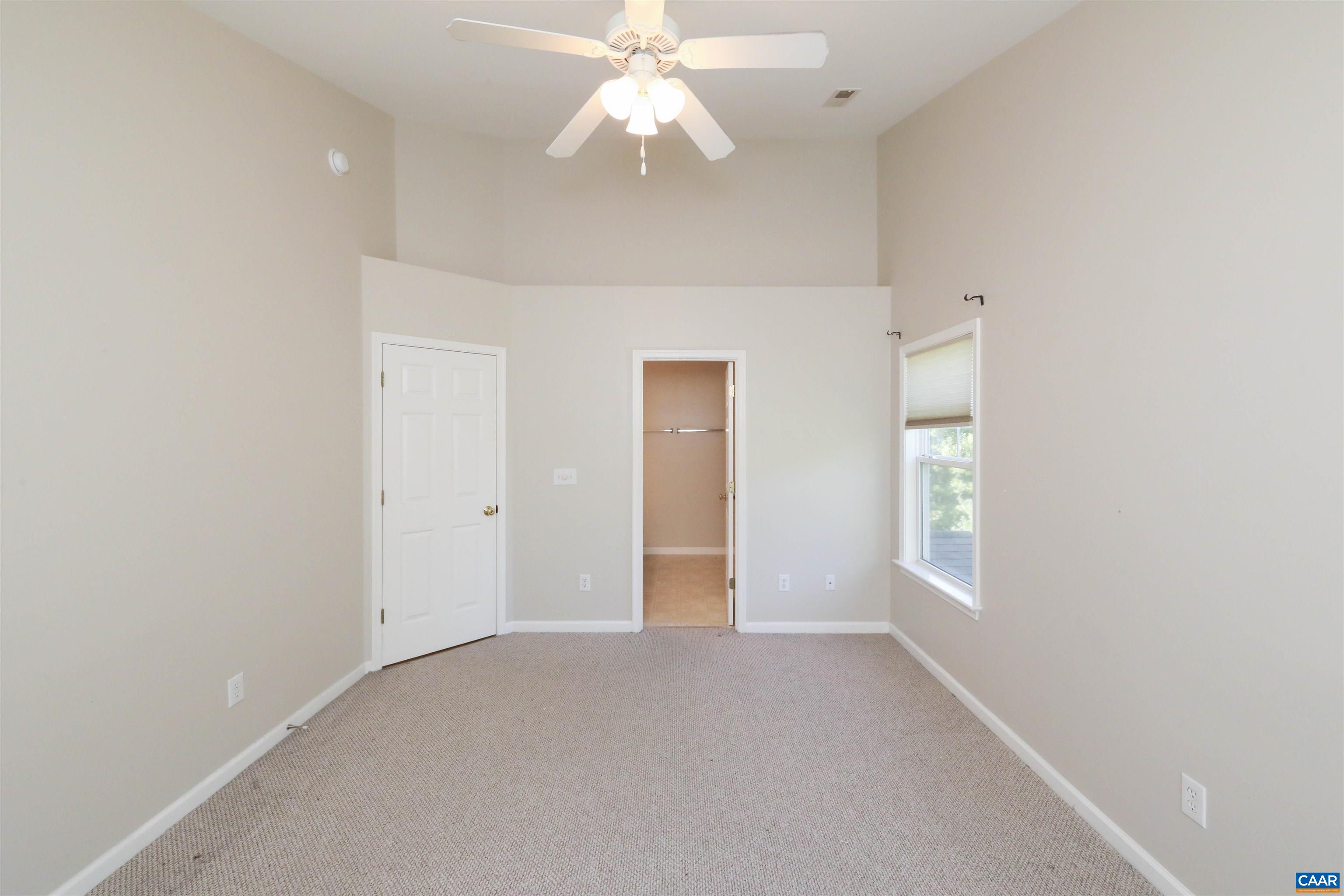 1342 Stoney Ridge Road Charlottesville, VA 22902 - Photo 34 of 47 an empty room with chandelier fan and windows